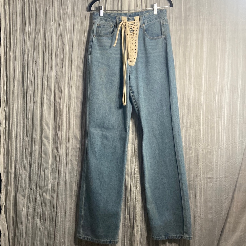 These are wide flare jeans with a lace tie in front. They are a medium fit.
